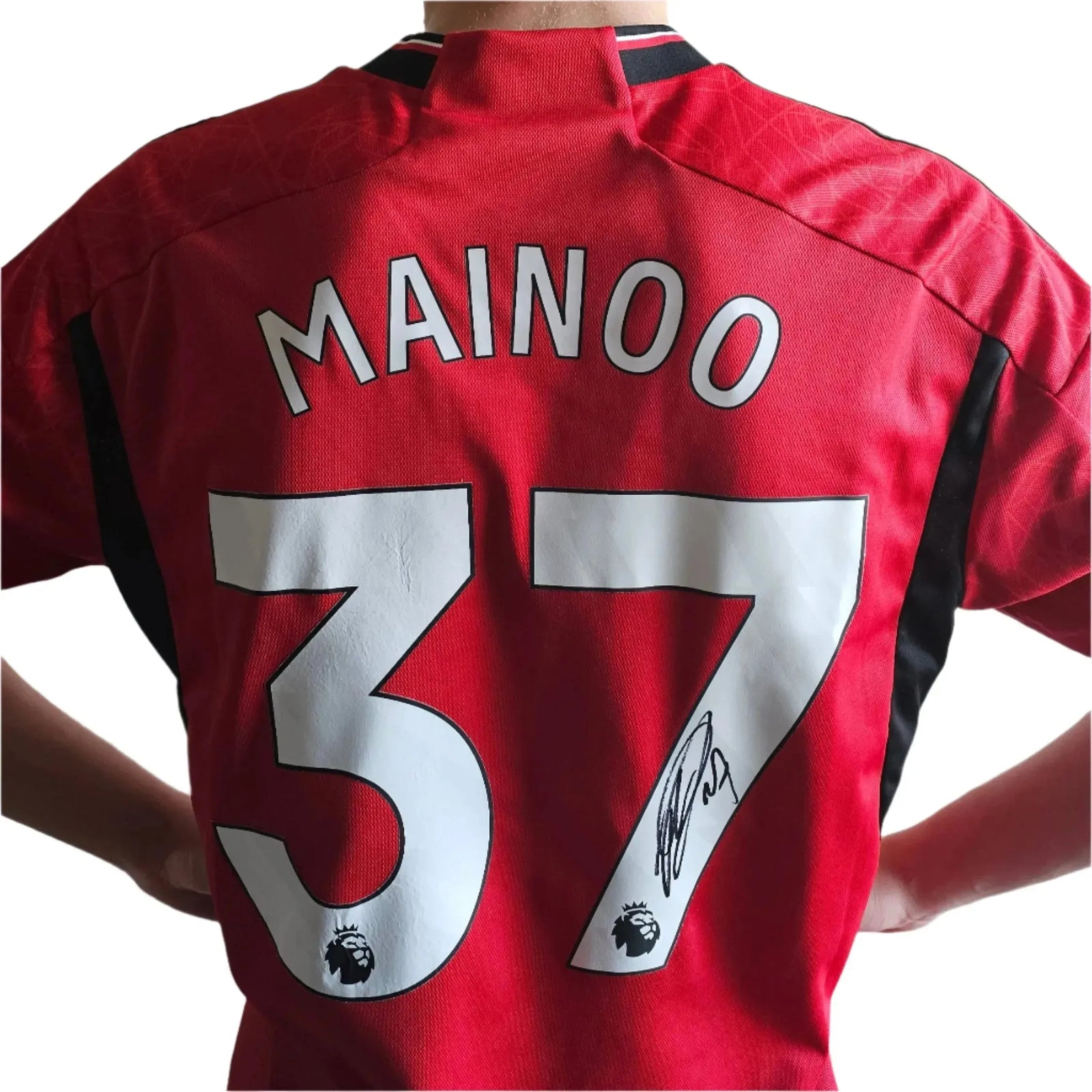 Back view showing the name Mainoo, No. 37, and a visible signature on a red soccer jersey.
