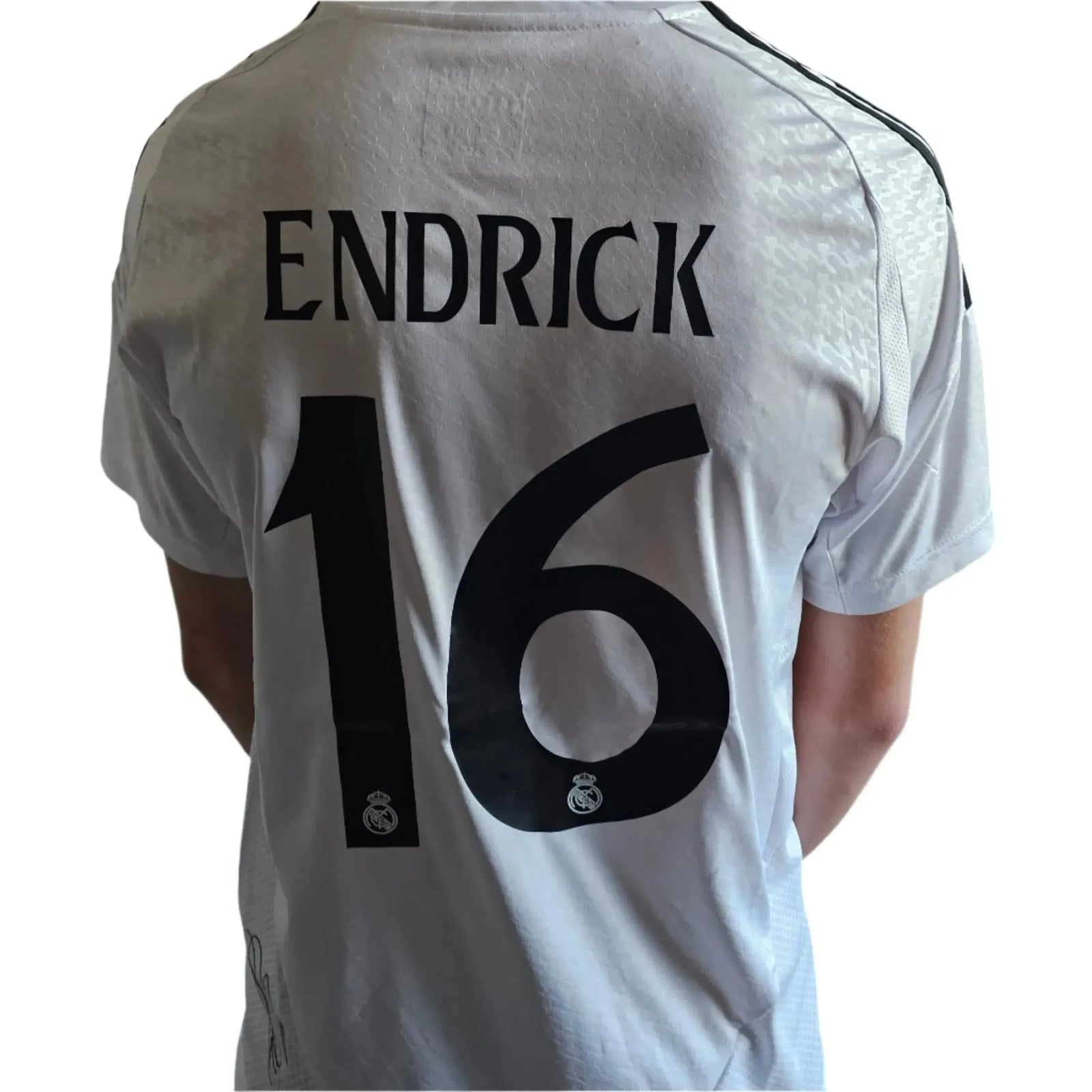 Back view showing Endrick, No. 16, and Real Madrid crest on a white signed football shirt.