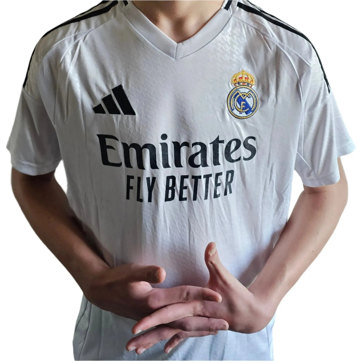 Front view of a white Real Madrid football shirt featuring the club crest and Emirates Fly Better sponsor.