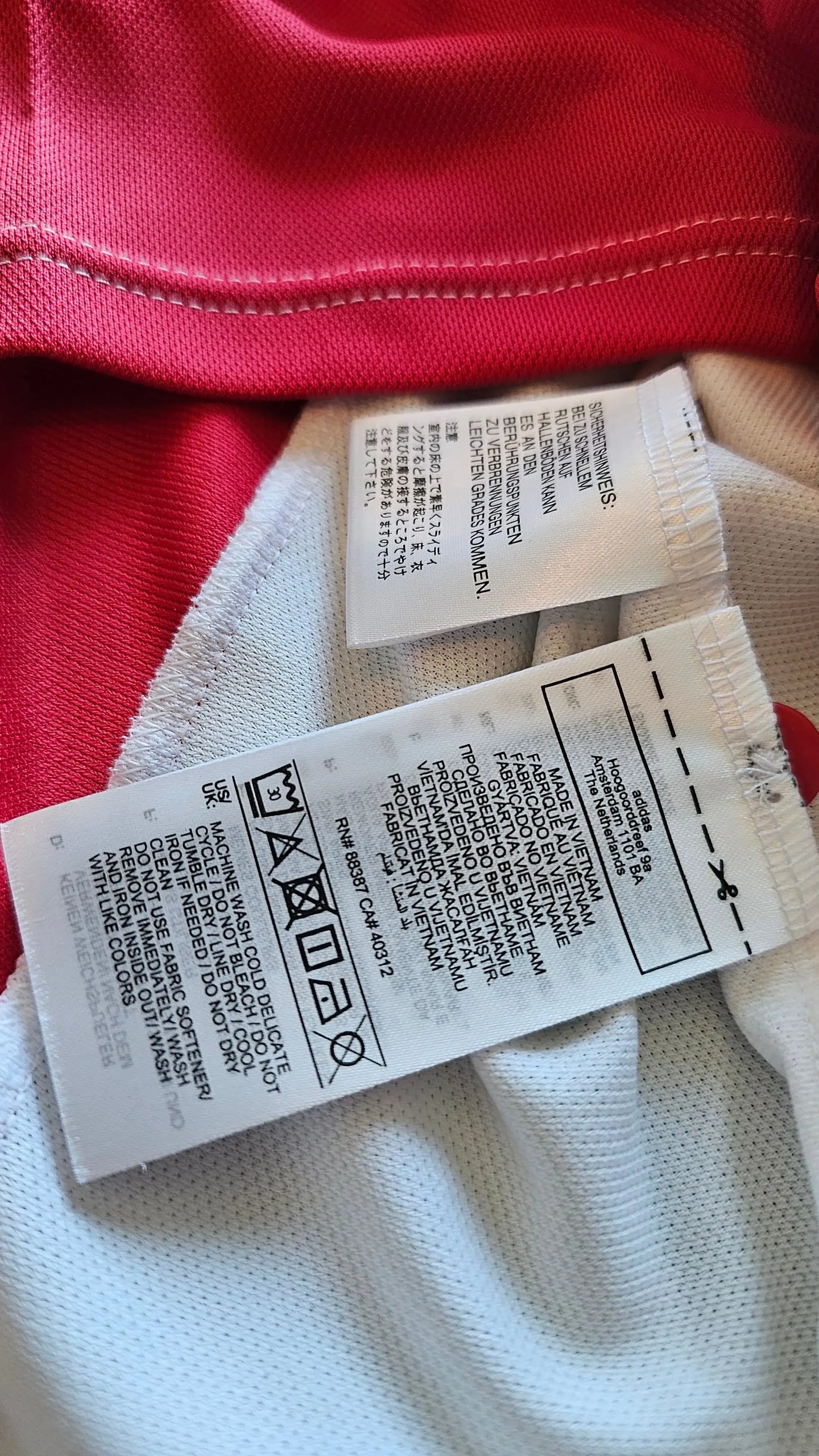 Care label showing washing instructions and size information for the Jari Litmanen signed football shirt.