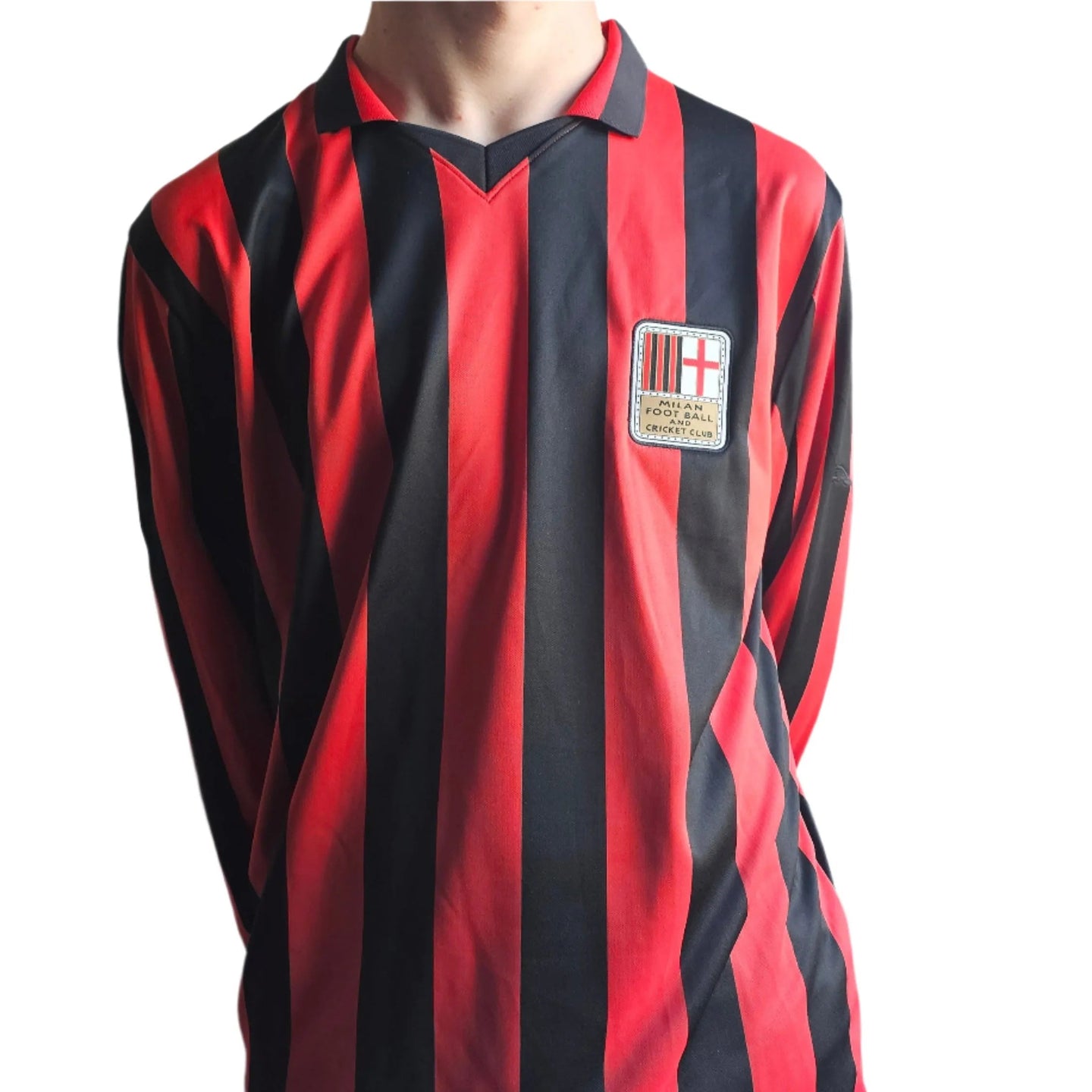 Front view of a red and black striped football shirt with the AC Milan crest visible.