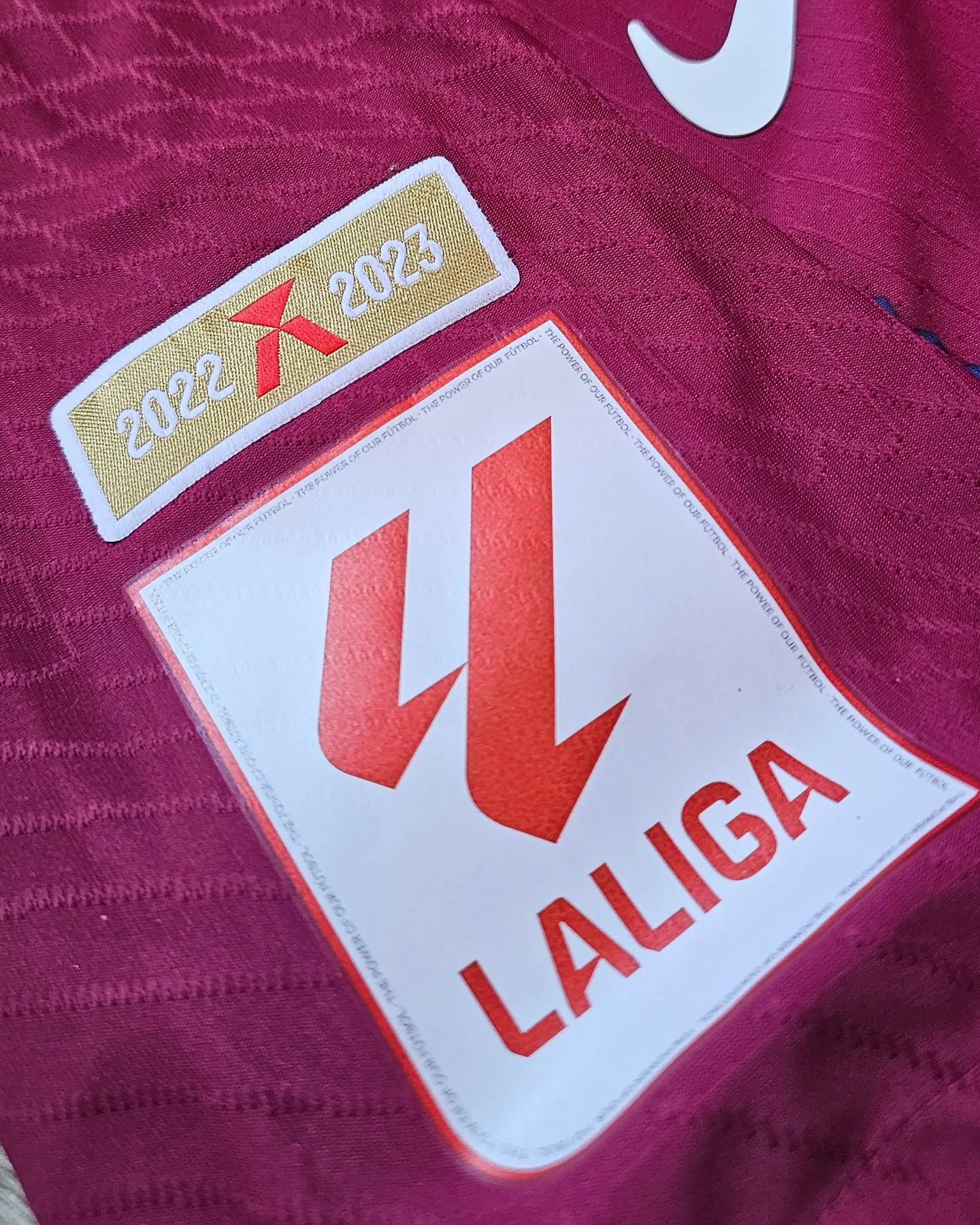 Detail view of LaLiga patch displaying the seasons 2022 and 2023 on a Barcelona shirt.