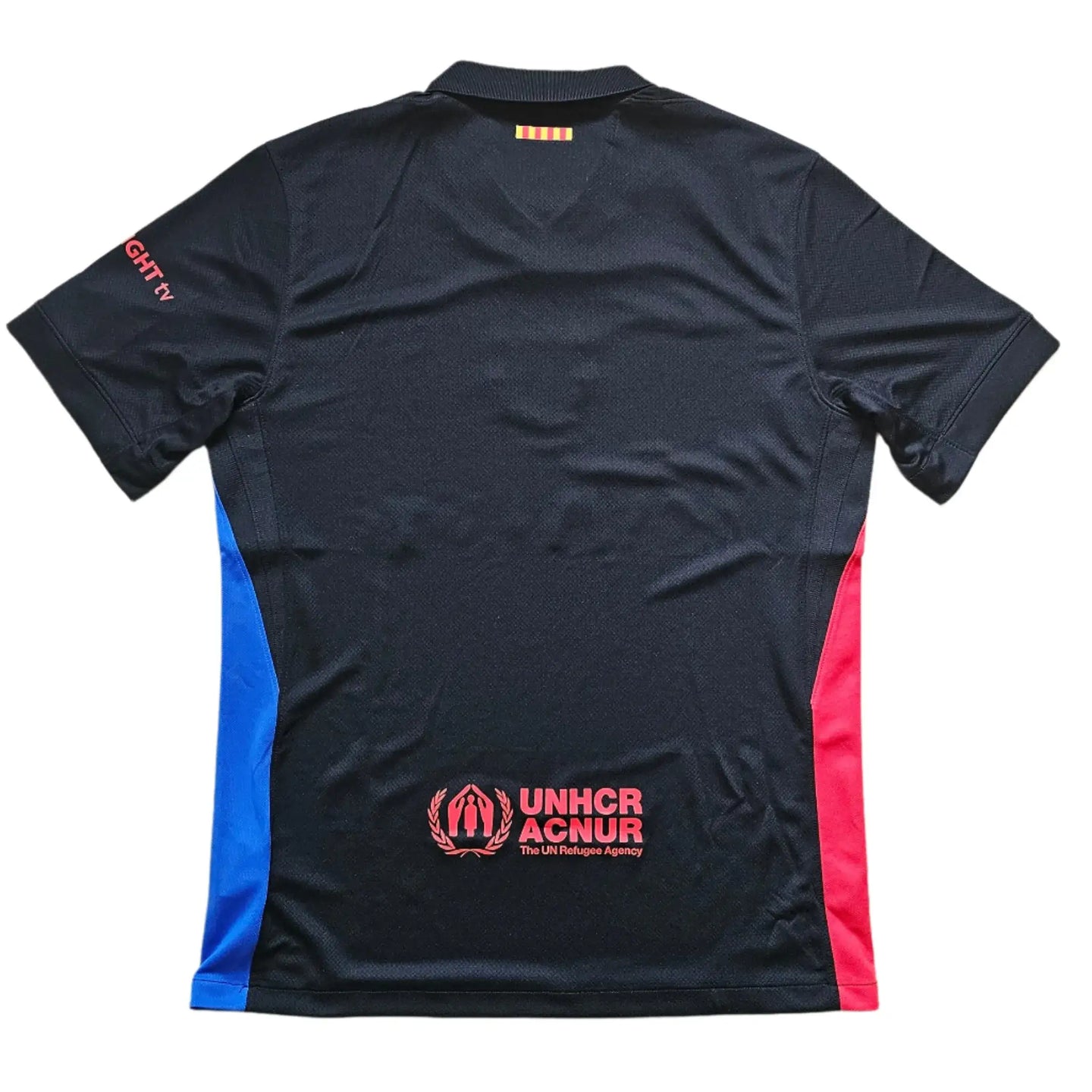Back view featuring the yellow Catalan flag, UNHCR logo, and red sponsor wordmark.