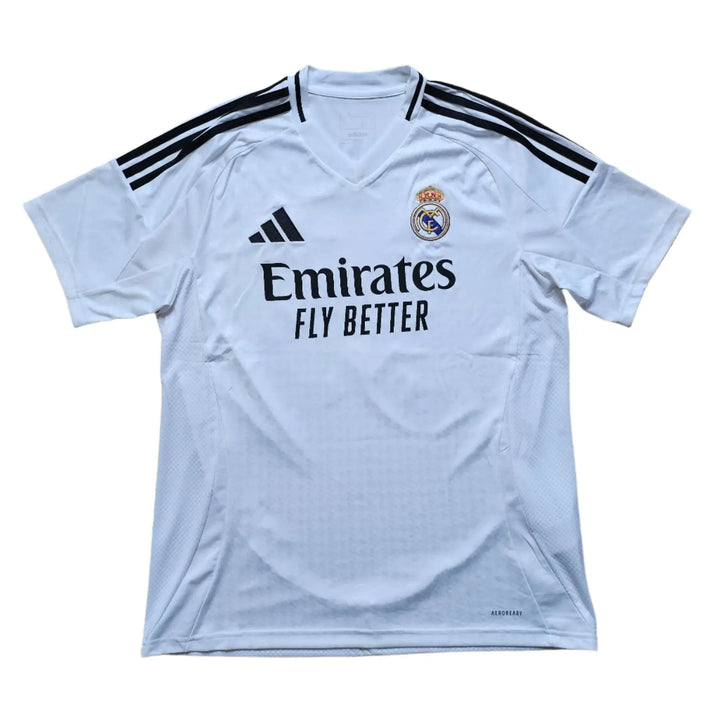Front view showing Real Madrid crest, Emirates sponsor, and adidas branding on a white football shirt.