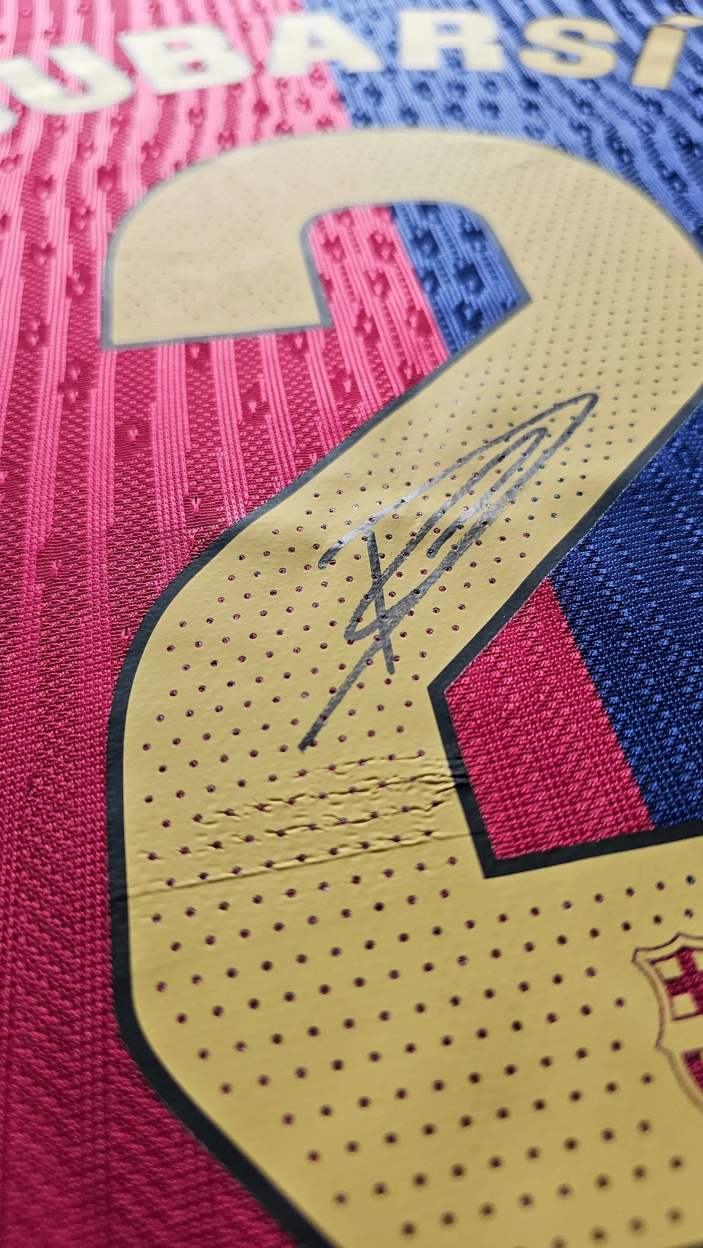 Close-up of No. 2 with Pau Cubarsí signature on Barcelona soccer jersey.