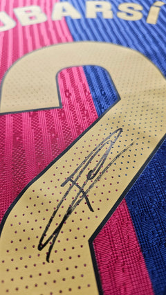 Close-up showing the signature of Pau Cubarsí beside the No. 2 on the Barcelona football shirt.