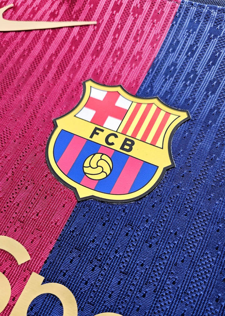 FC Barcelona crest in red and blue colors with golden Nike logo above it.