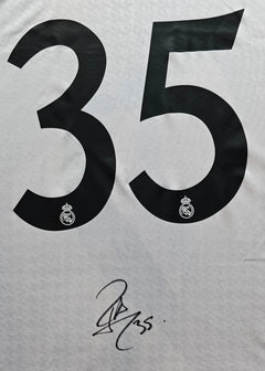 Detail showing No. 35 and signature on a Real Madrid football shirt.