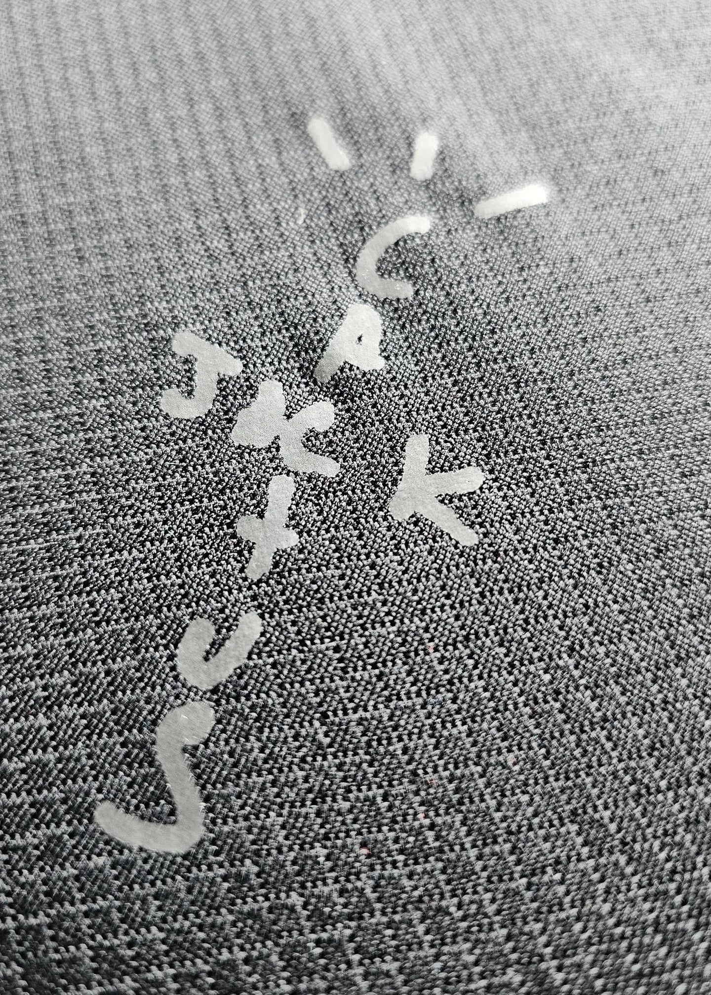 Signature detail featuring letters C, A, K, J, and S on the fabric.