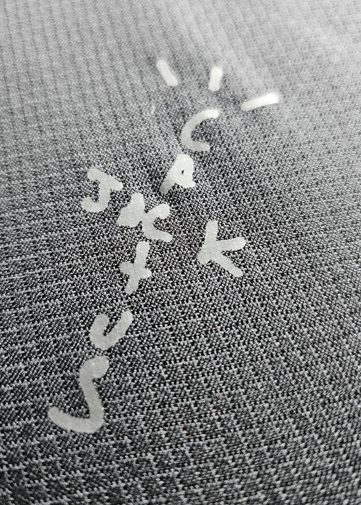 Signature detail featuring letters C, A, K, J, and S on the fabric.