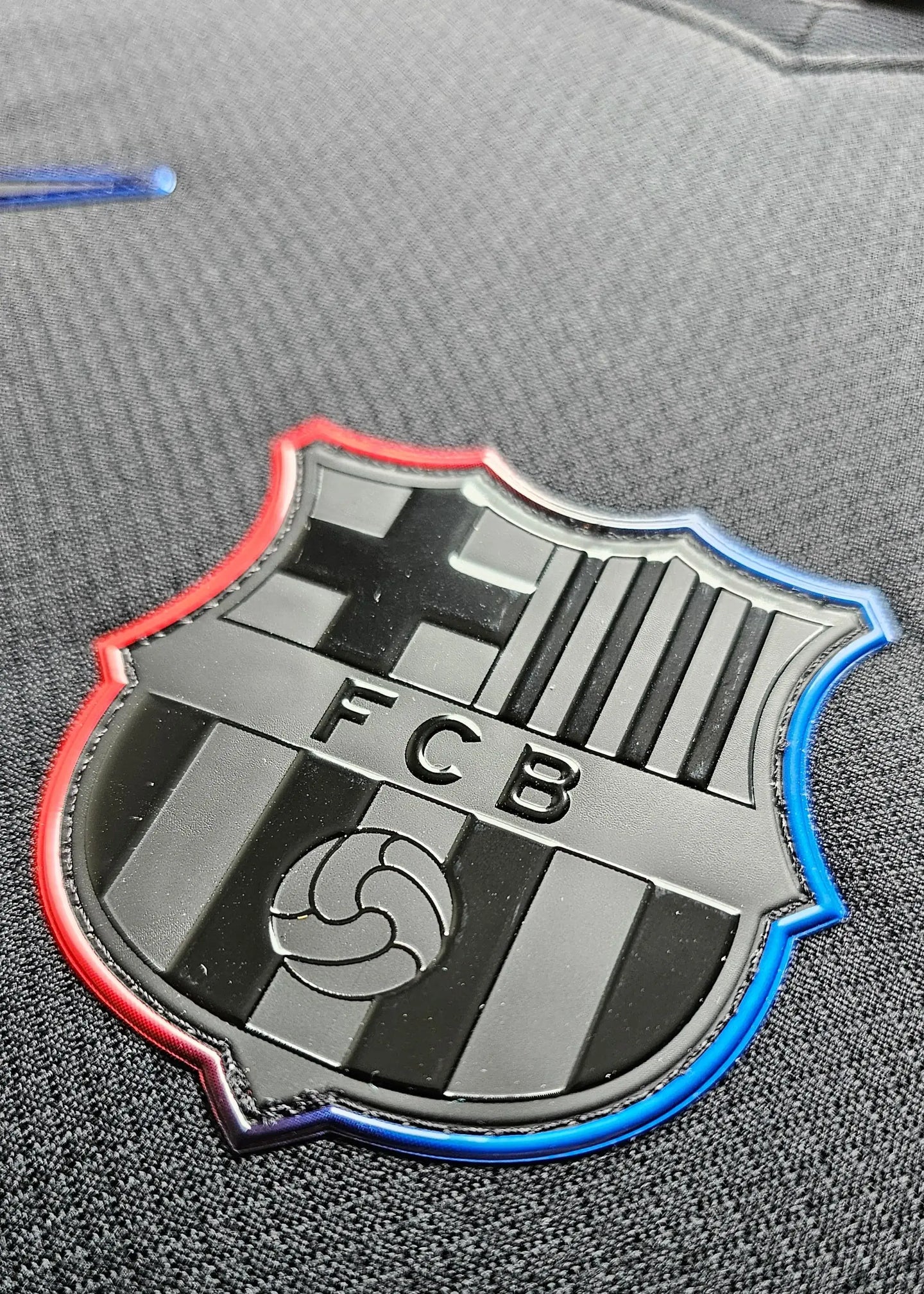 Crest detail featuring the FC Barcelona logo with black and color accents.