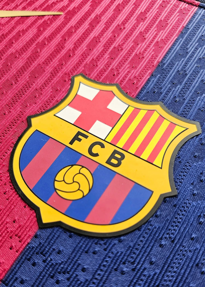 Crest detail featuring FC Barcelona logo with red and blue stripes and yellow accents.