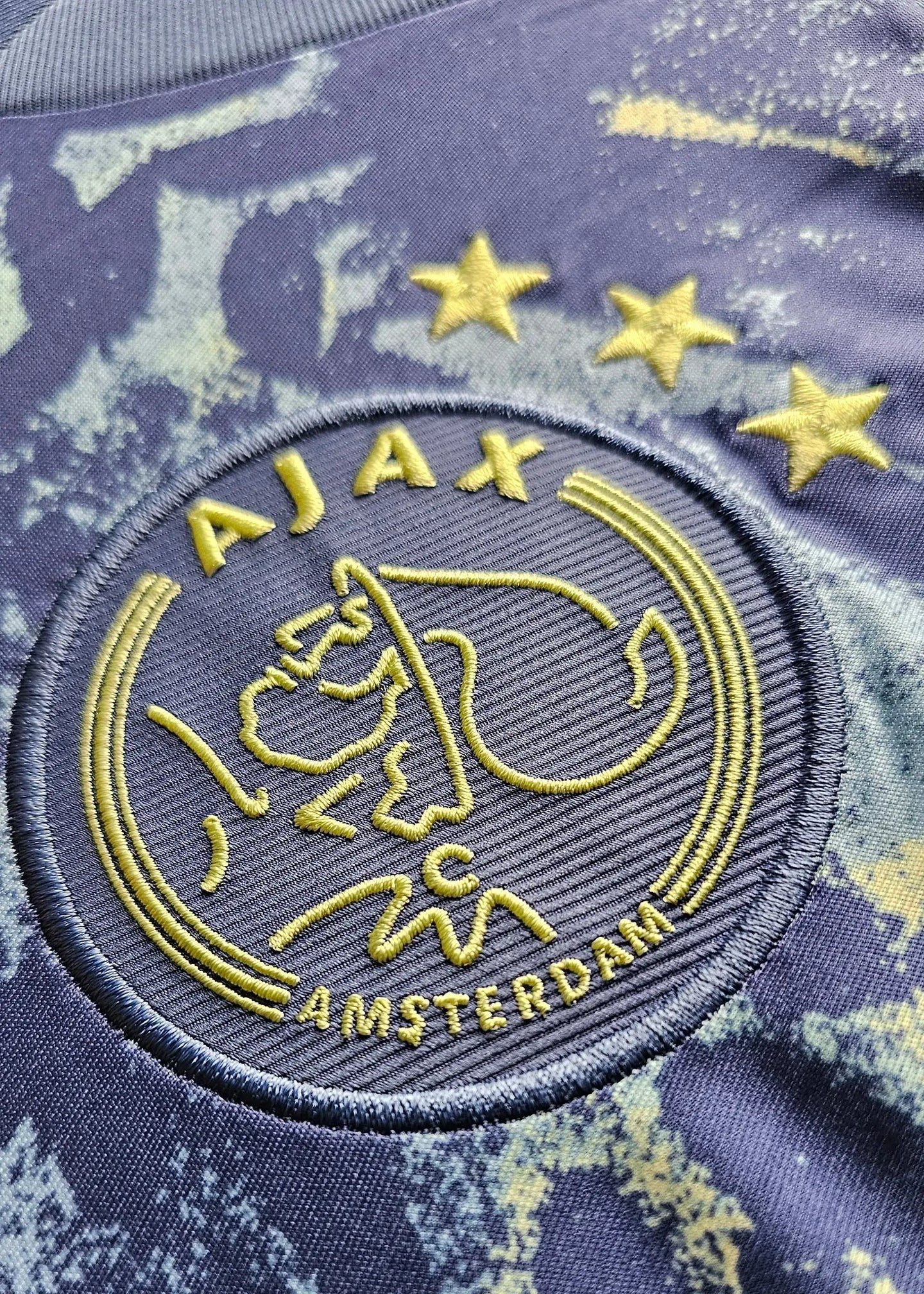 Crest detail featuring the AJAX logo with three stars and the text AMSTERDAM.