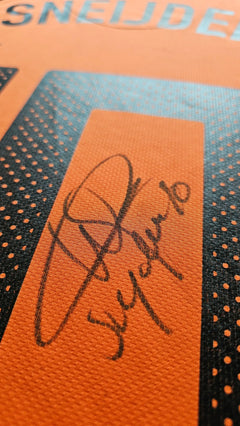 Close-up of Wesley Sneijder signature on orange football shirt, No. 10, with black detailing.