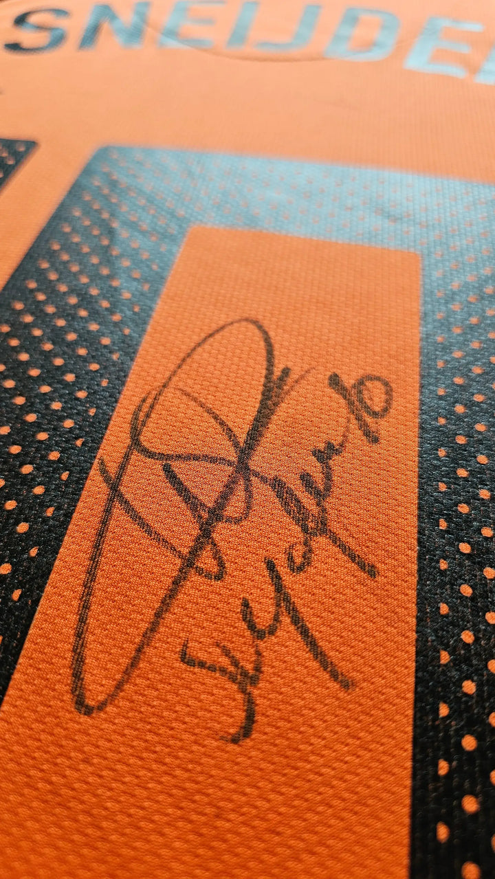 Close-up of Wesley Sneijder signature on orange football shirt, No. 10, with black detailing.