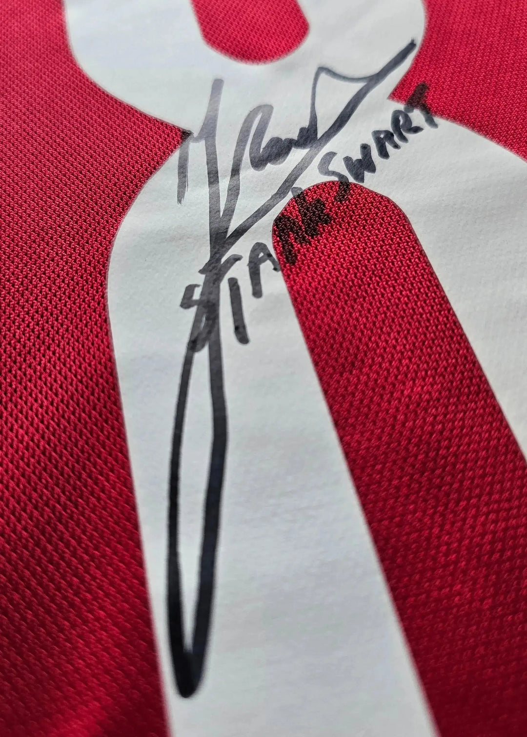 Close-up of signature detail on No. 8 in white on red Sjaak Swart Ajax shirt.