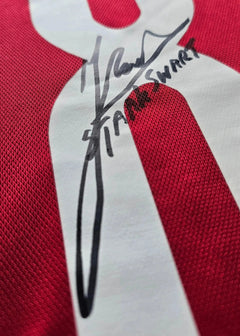 Close-up of signature detail on No. 8 in white on red Sjaak Swart Ajax shirt.