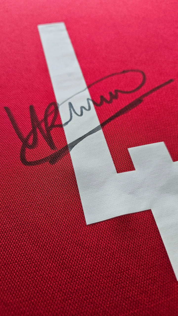 Detail view featuring the No. 4 and Ronald Koeman's signature on a red football shirt.