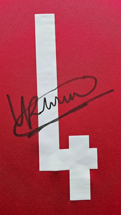 Detail showing signature and number 4 on a red football shirt.