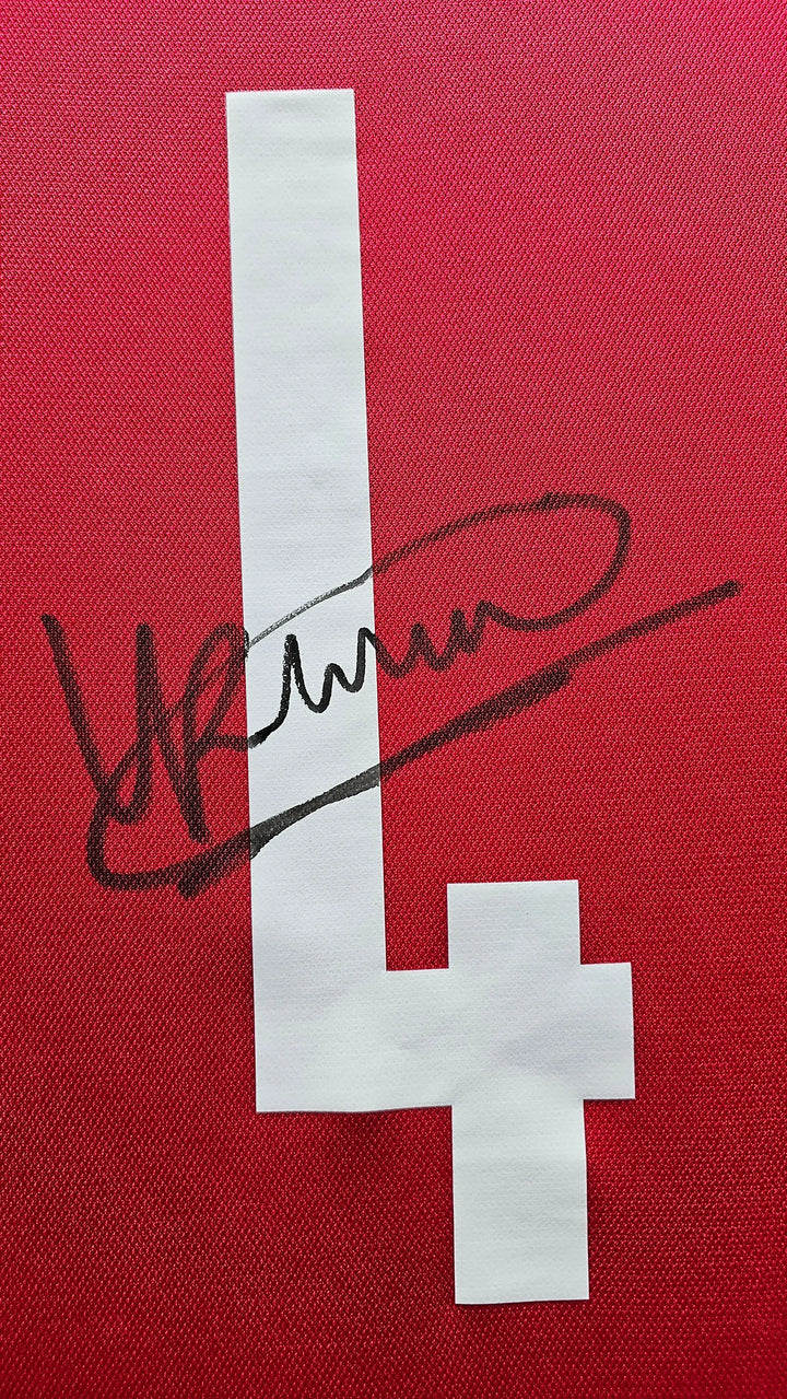 Detail showing signature and number 4 on a red football shirt.