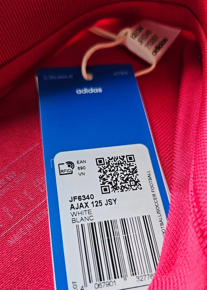 White label with product details for Ajax 125 anniversary shirt by adidas.