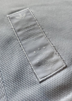 Detail showing AFC Ajax 125th Anniversary patch with three stars and embossed '18 MAART 1900'.