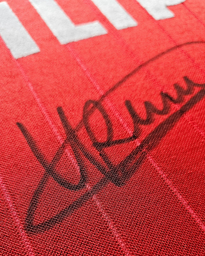 Close-up of signature on red football shirt with white lettering from Ronald Koeman.