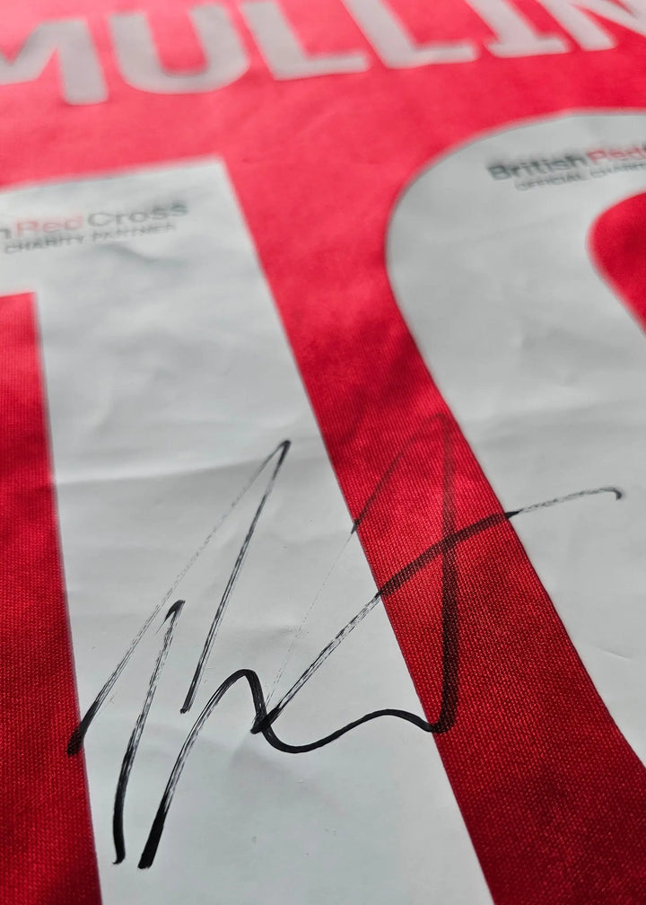 Signature of Mullin on the No. 10 Wrexham AFC soccer jersey in red.
