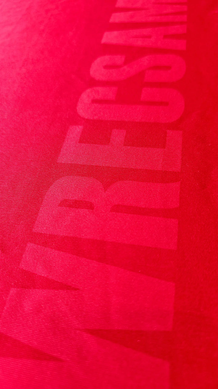 Close-up view of Wrexham AFC lettering on a red signed soccer jersey by Phil Parkinson.