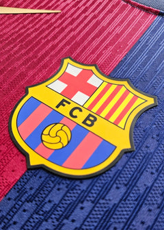 Crest detail featuring the FC Barcelona logo with FCB initials and a yellow soccer ball.