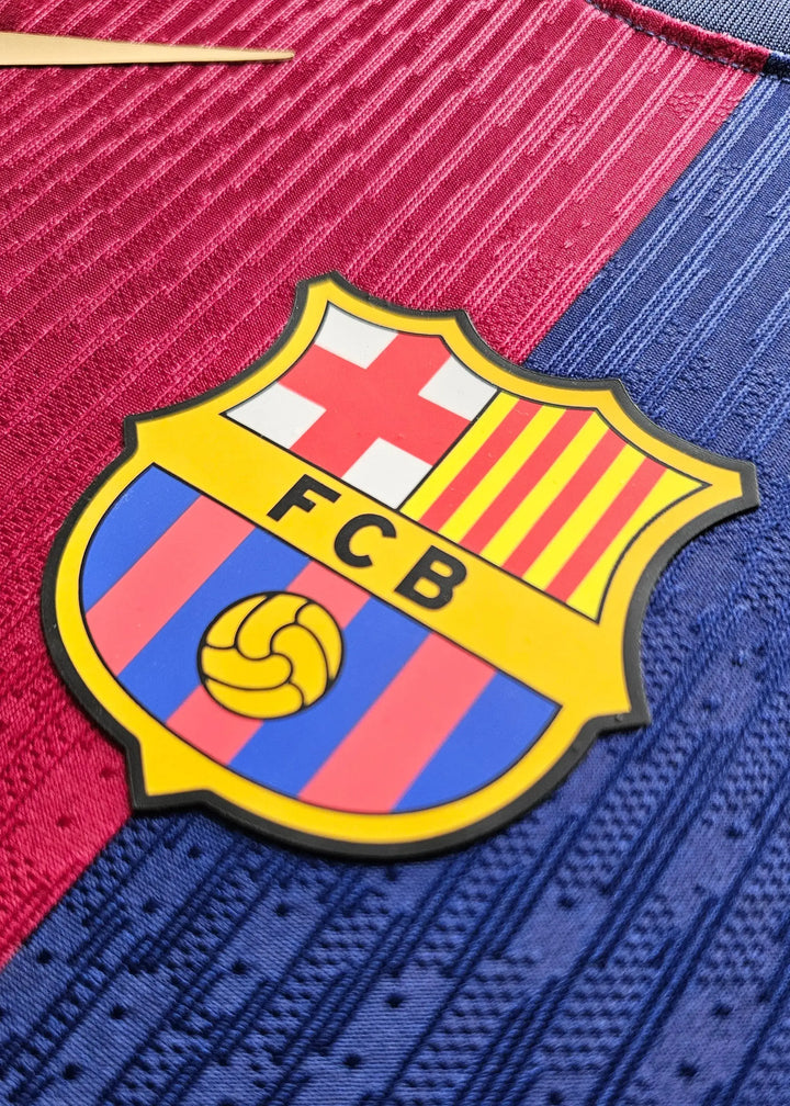 Crest detail featuring the FC Barcelona logo with FCB initials and a yellow football ball.