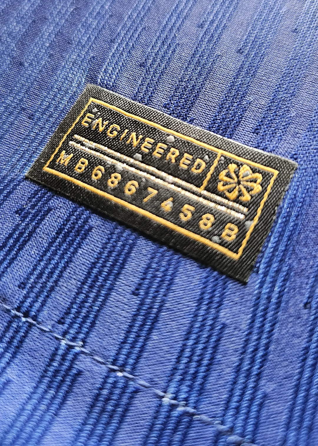 Close-up showing the engineered label with text 'ENGINEERED' and code 'MB6867458B'.