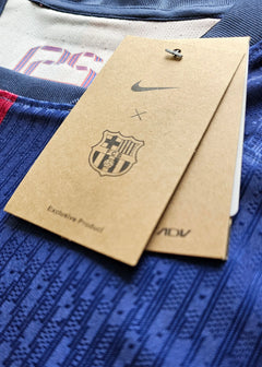 Detailed view of FC Barcelona tag featuring Nike logo and crest, with visible text stating 'Exclusive Product'.