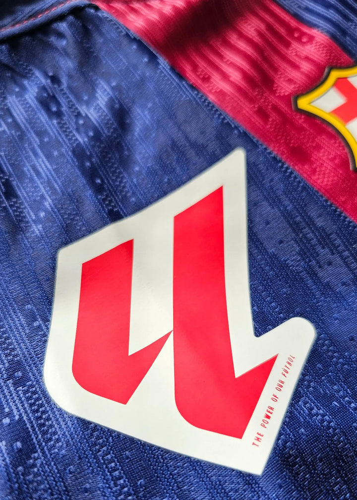 Detail view of FC Barcelona crest and logo featuring red and blue colors.