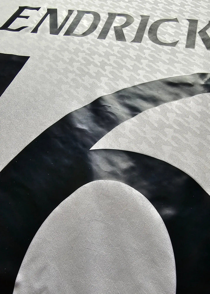 Close-up of the No. 16 in black and the name &