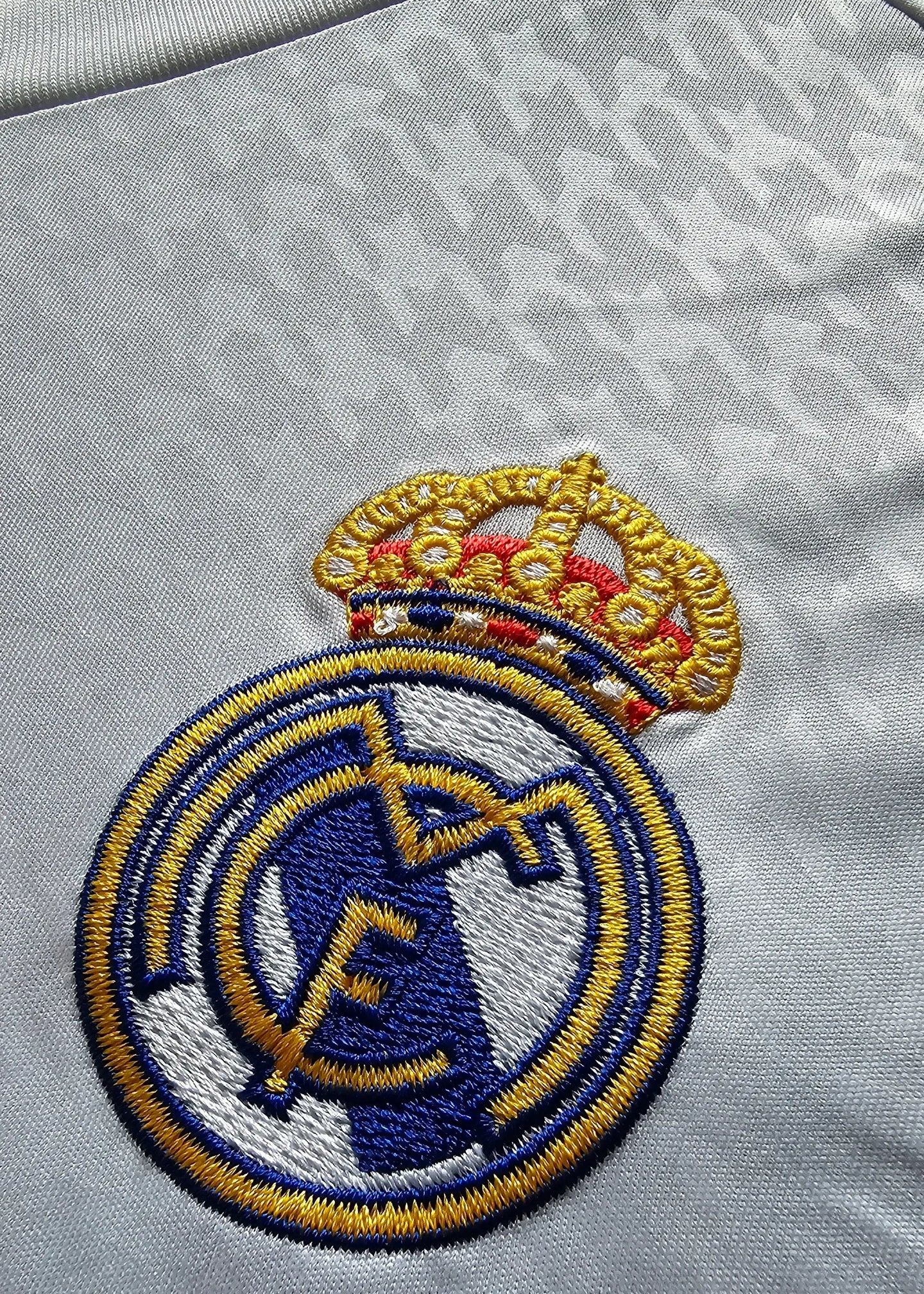 Close-up of the Real Madrid crest featuring a crown and embroidered details.