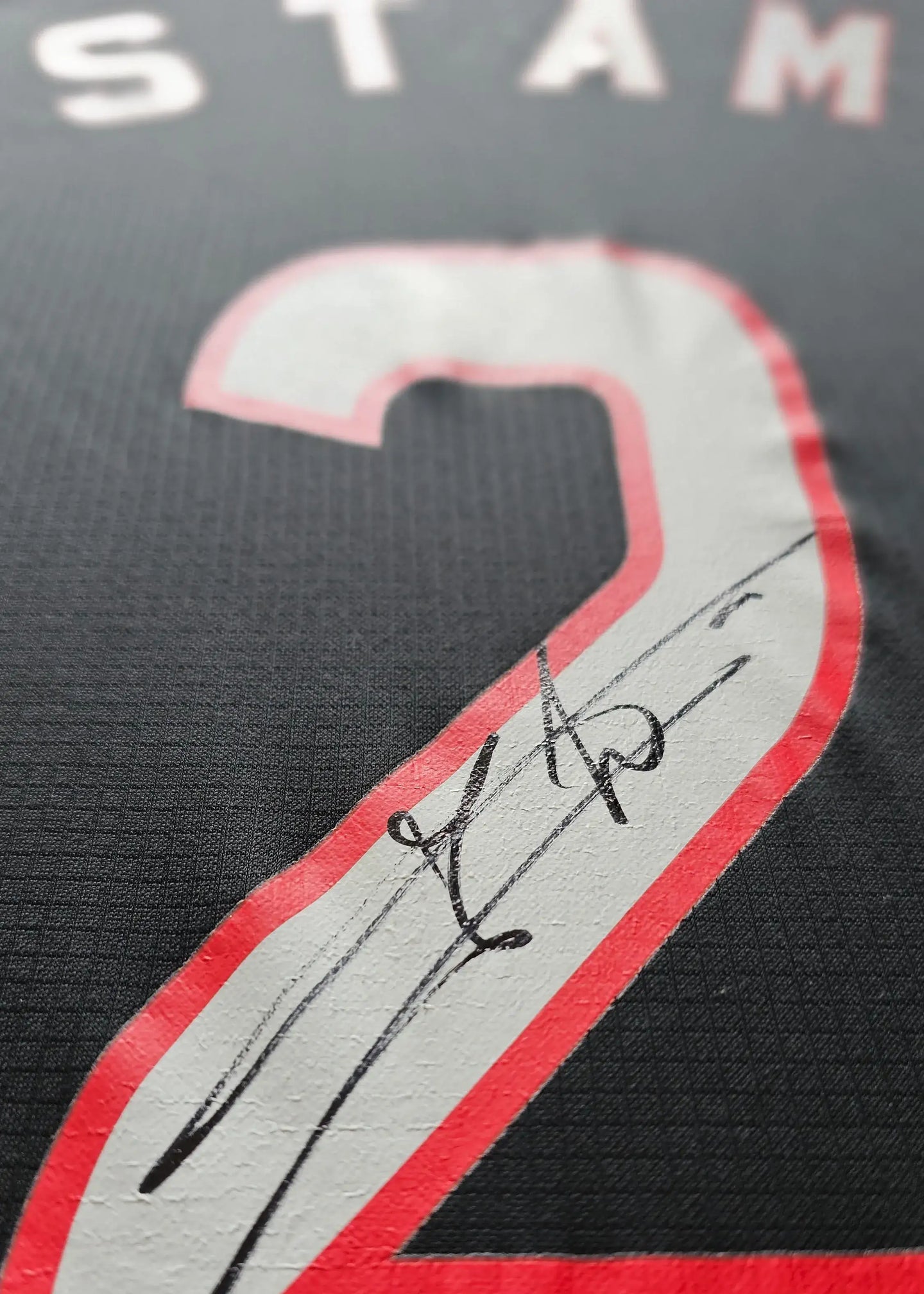 Detail view showcasing the signature on the No. 2 of Jaap Stam Ajax football shirt.