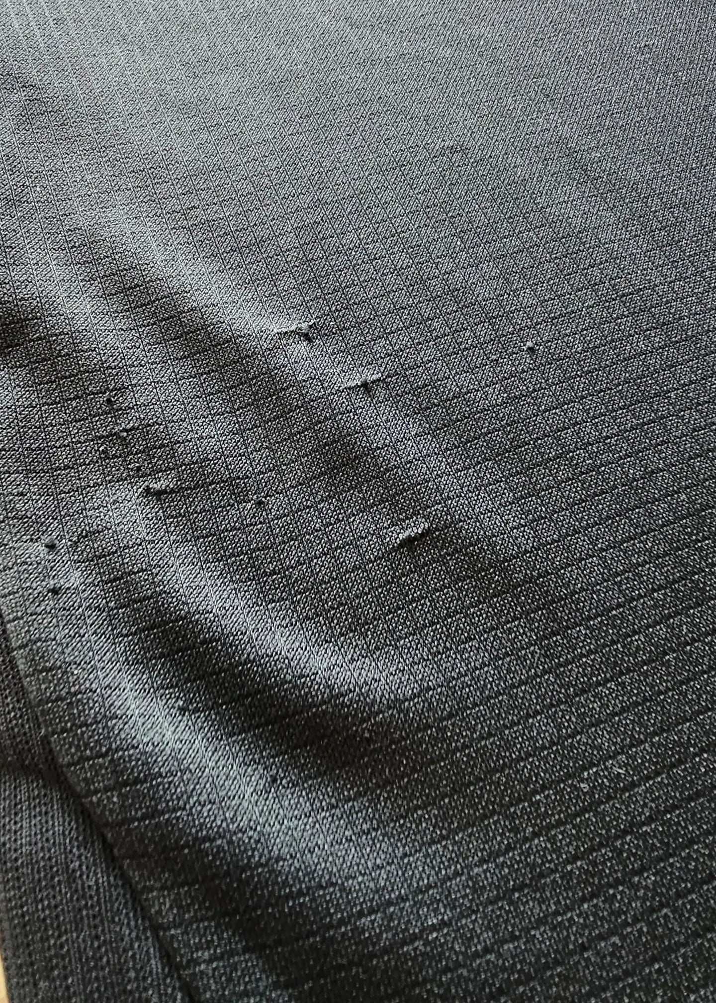 Close-up showing fabric texture and minor wear on the signed football shirt.