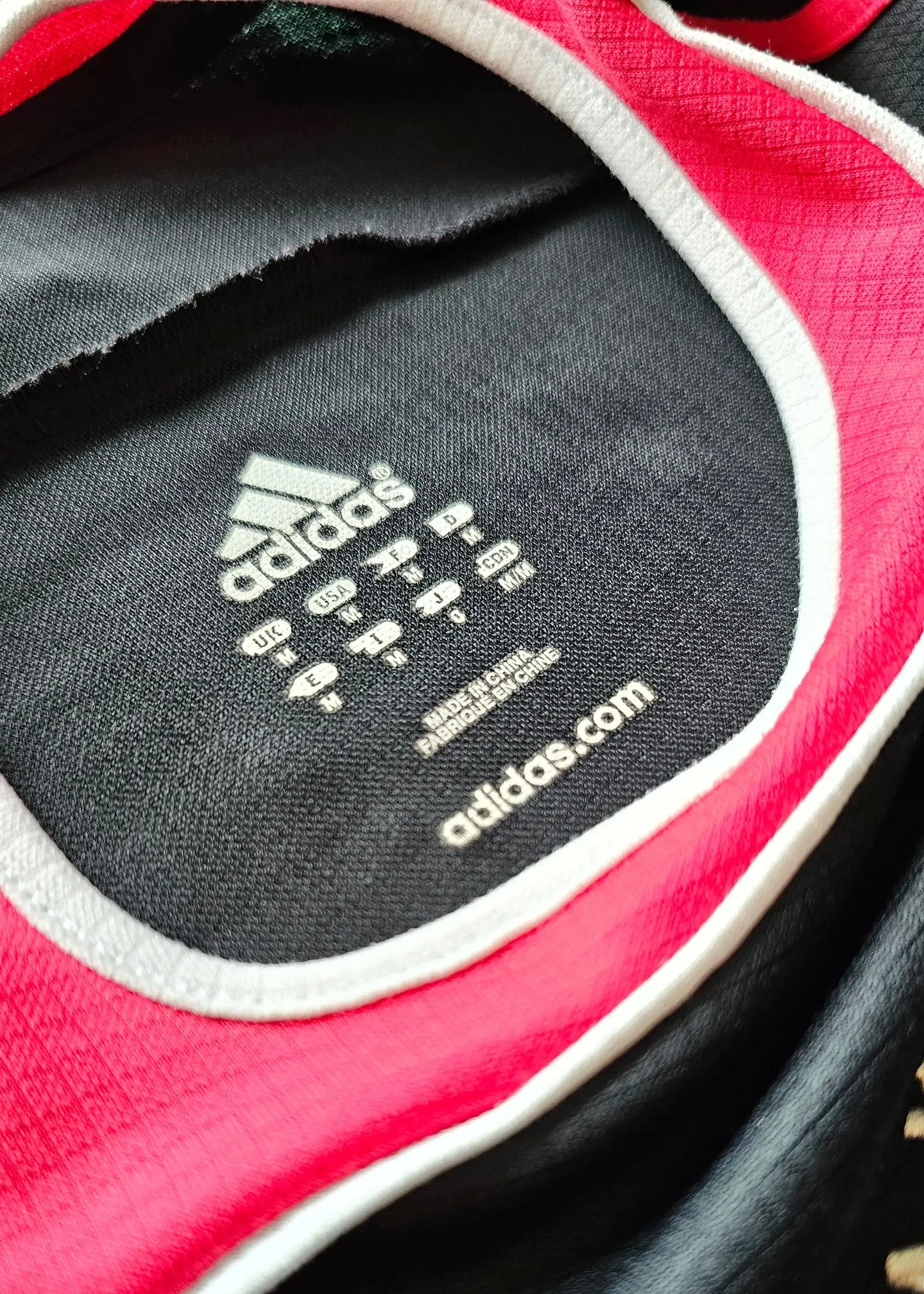 Interior label of Jaap Stam 2 Ajax signed football shirt, featuring adidas logo and care instructions.