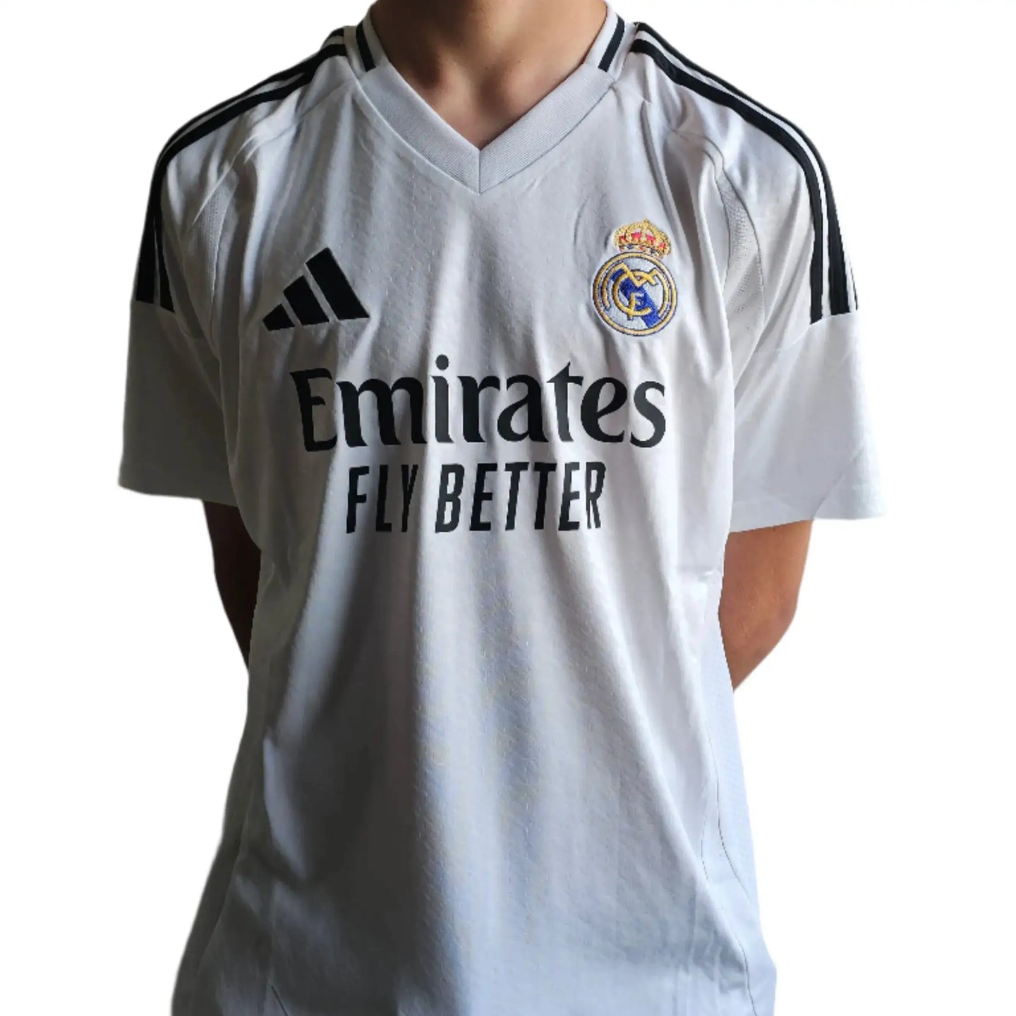 Front view of a white Real Madrid soccer jersey featuring the Emirates sponsor and club crest.