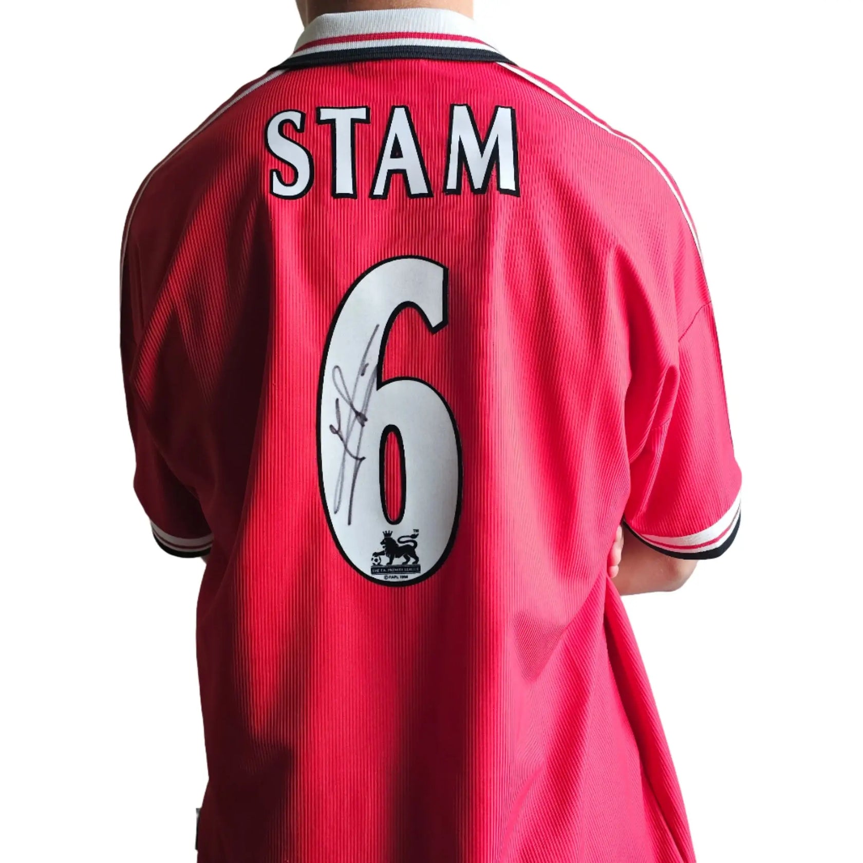 Back view showing STAM, No. 6, and a visible signature on a red football shirt.