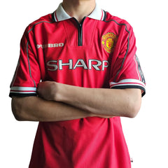 Back view showing the Manchester United crest and the word 'SHARP' prominently displayed.