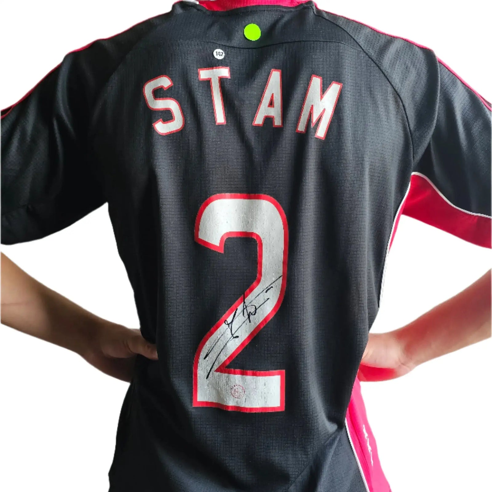 Back view showing player name STAM, squad number 2, and signature.