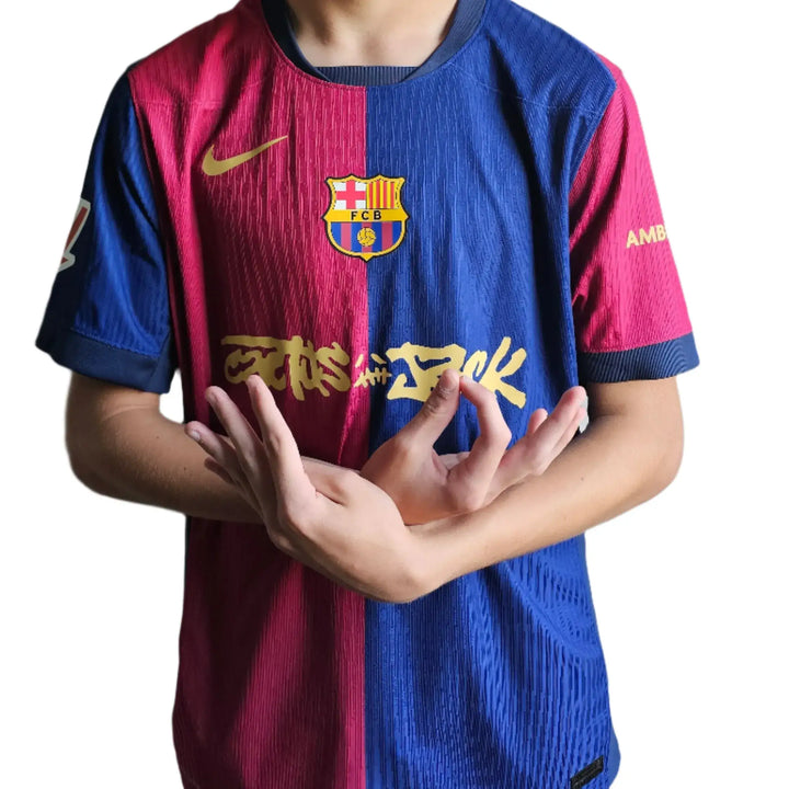 Front view of Barcelona 2025 football shirt featuring Lamine Yamal and a gold signature detail.