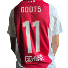 Back view showing Godts, No. 11, and Ziggo Sport branding on red and white football shirt.