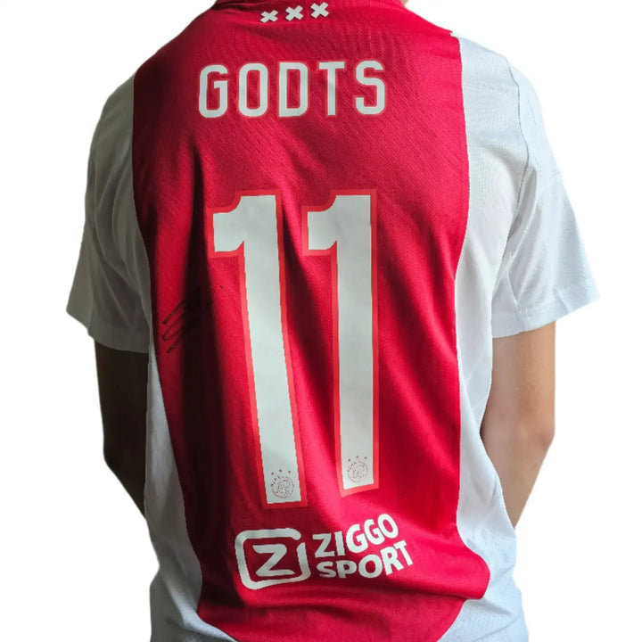 Back view showing Godts, No. 11, and Ziggo Sport branding on red and white football shirt.