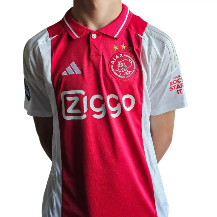 Front view of Mika Godts 11 Ajax football shirt featuring Ziggo logo and two stars.