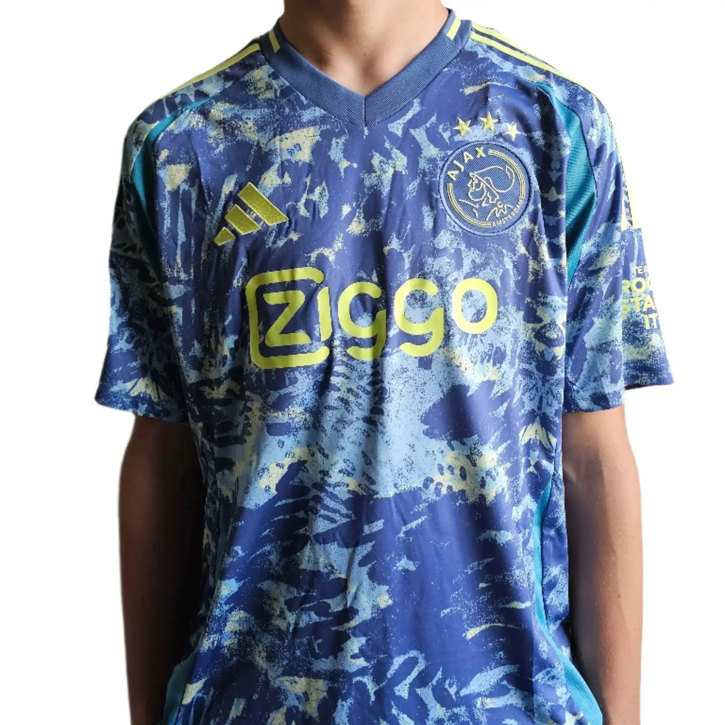 Front view of Mika Godts 11 Ajax Signed Away Shirt with Ziggo sponsor and crest featuring two stars.