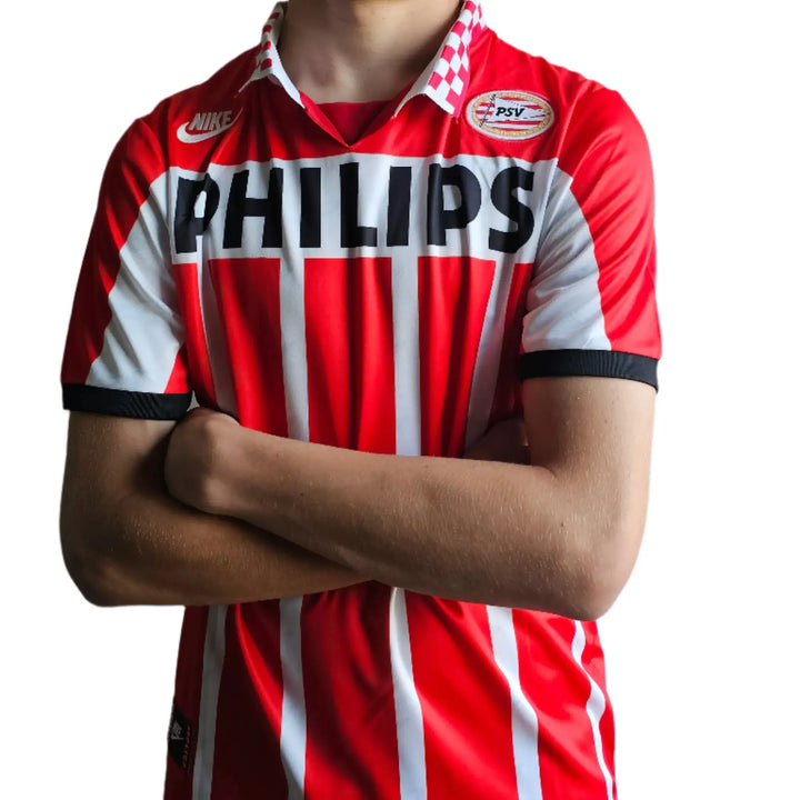 Front view of a PSV Eindhoven football shirt featuring red and white stripes and PHILIPS on the front.