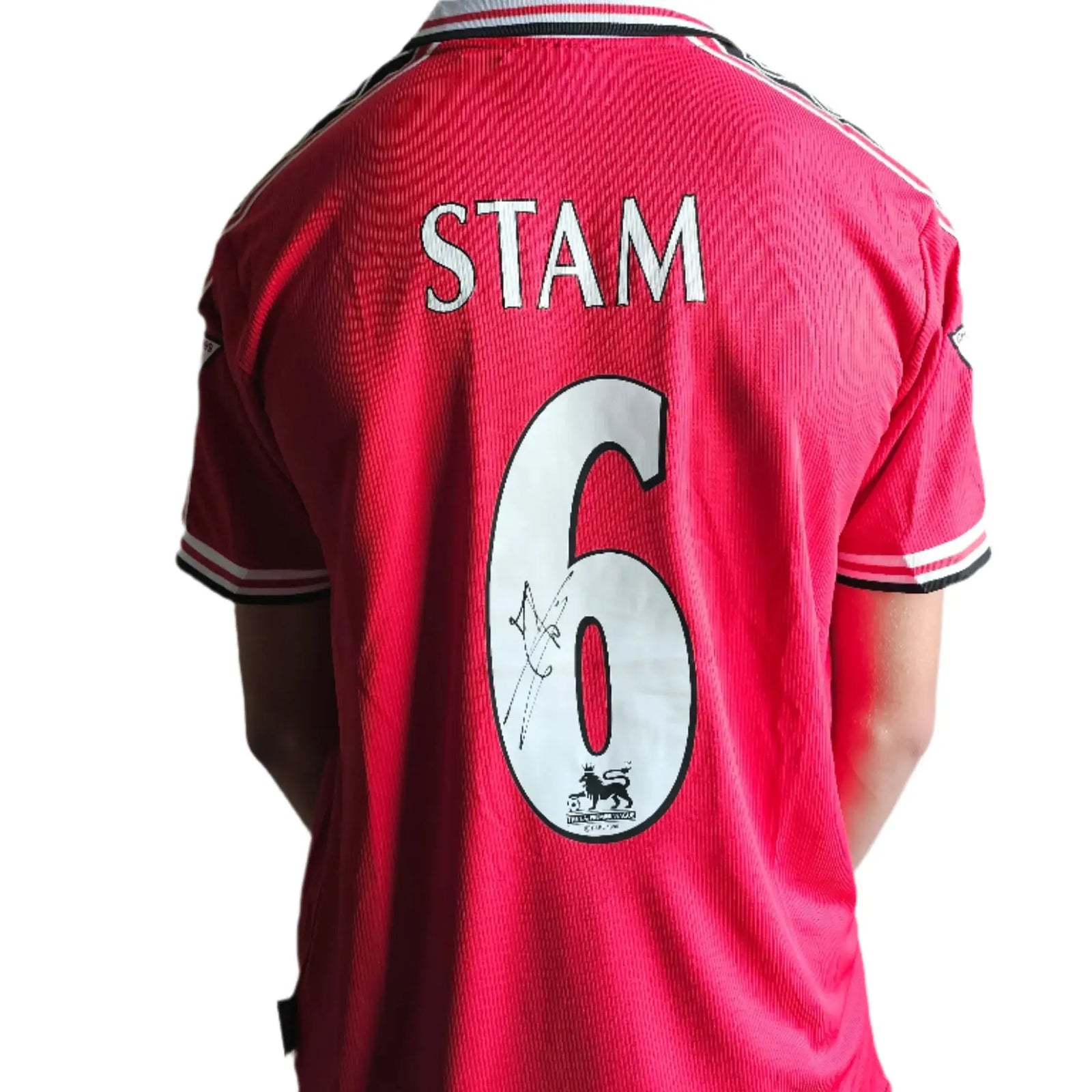 Back view of Manchester United shirt showing STAM and No. 6 with signature detail.
